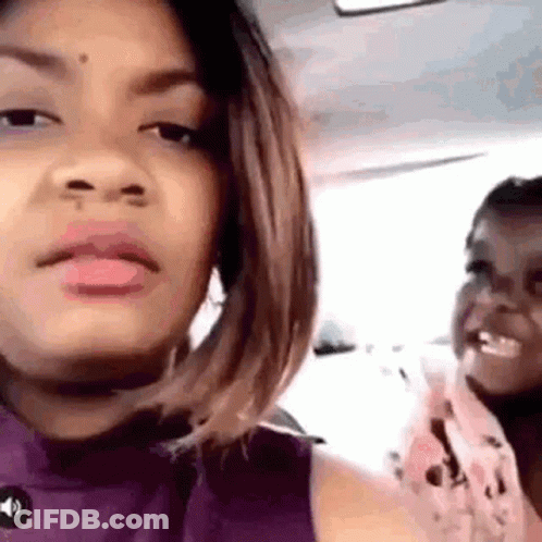 Woman In Purple Shirt With Little Girl In Car GIF
