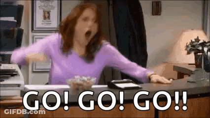 Woman In Purple Shirt Yawning At Desk GIF