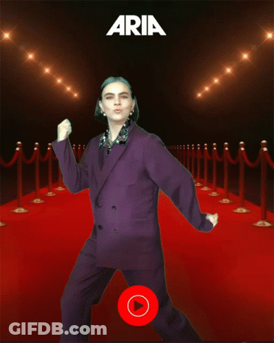 Woman In Purple Suit Dancing On Red Carpet With Aria GIF