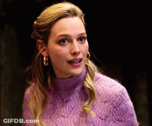 Woman In Purple Sweater And Gold Hoop Earrings GIF