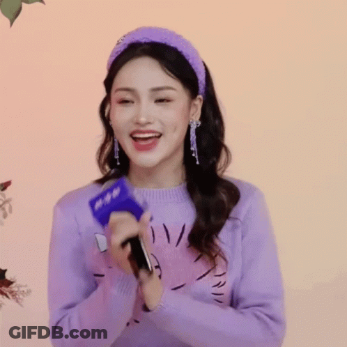 Woman In Purple Sweater And Headband Holding Microphone GIF