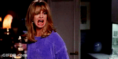 Woman In Purple Sweater Making Funny Face GIF