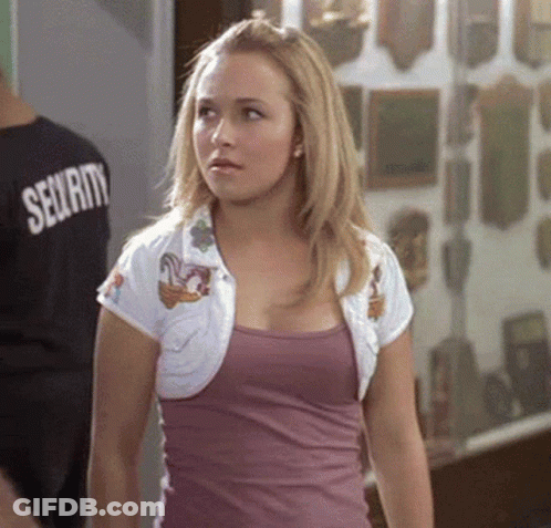 Woman In Purple Tank Top And White Jacket Standing In Front Of Man In Security Shirt GIF