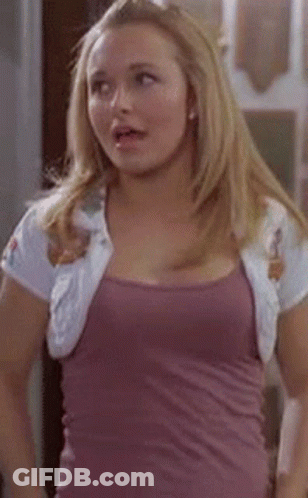 Woman In Purple Tank Top And White Jacket Standing In Room GIF