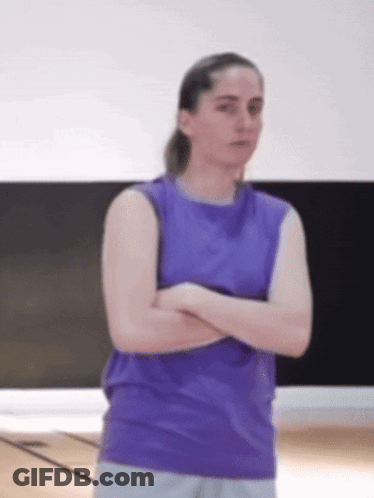 Woman In Purple Tank Top Arms Crossed In Gym GIF