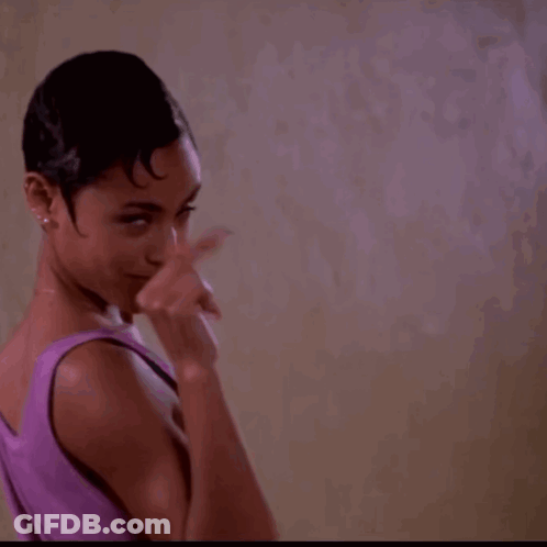 Woman In Purple Tank Top Pointing Finger Up GIF