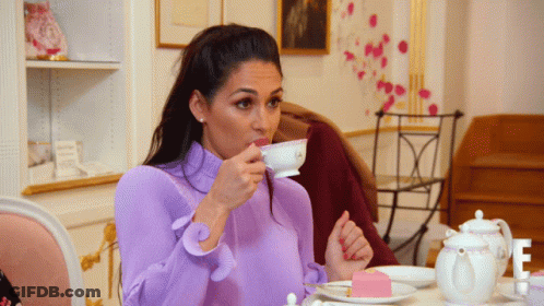 Woman In Purple Top Drinking From Cup GIF