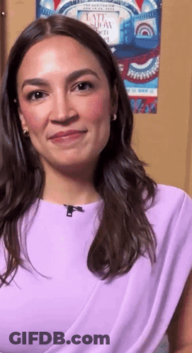 Woman In Purple Top Smiling In Front Of Late Show Poster GIF