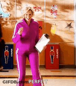 Woman In Purple Tracksuit Holding Clipboard GIF