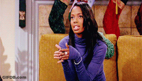 Woman In Purple Turtleneck Sitting On Yellow Couch GIF