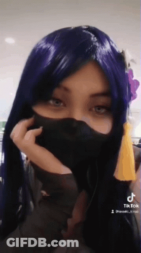 Woman In Purple Wig And Black Mask GIF