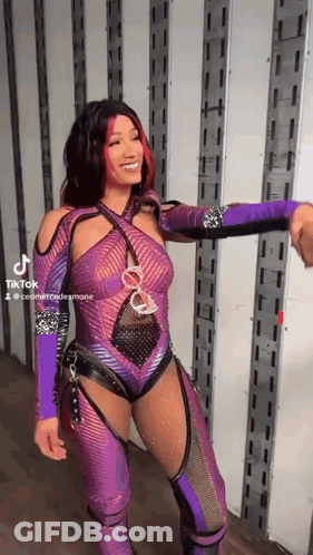 Woman In Purple Wrestling Outfit Shaking Hands With Man In Truck GIF