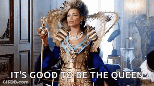 Woman In Queen Costume Holding Crown And Scepter GIF