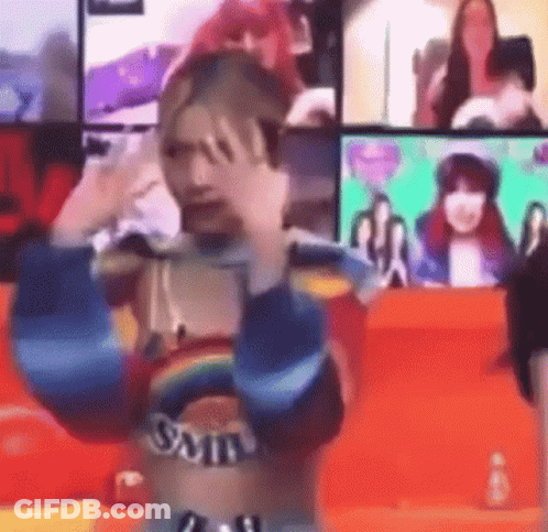 Woman In Rainbow Top Making Funny Face At Screen GIF