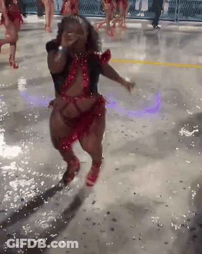 Woman In Red And Black Dancing On Wet Surface GIF