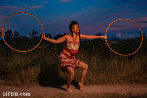 Woman In Red And White Dress Holding Two Hoops GIF
