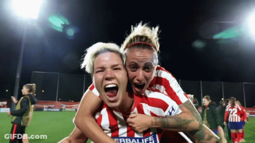 Woman In Red And White Herbalife Jersey Holding Another On Shoulders GIF