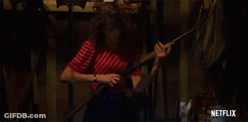 Woman In Red And White Striped Shirt Holding Shotgun GIF