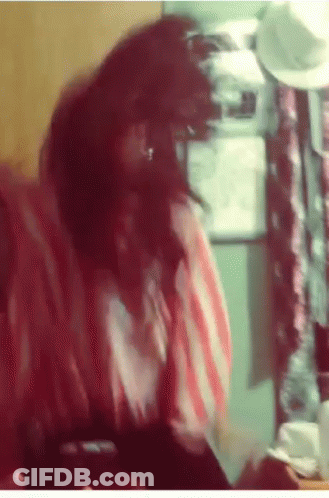 Woman In Red And White Striped Shirt Sitting In Front Of Refrigerator GIF