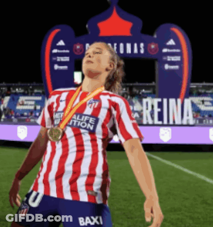 Woman In Red And White Striped Shirt With Medal On Soccer Field GIF