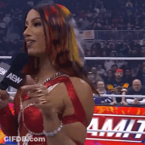 Woman In Red And White Wrestling Outfit Holding AEW Microphone GIF