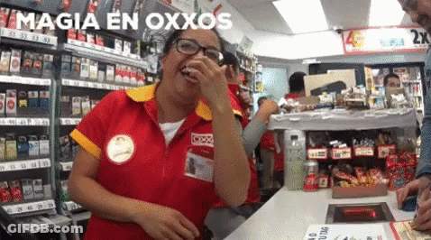 Woman In Red And Yellow Uniform Laughing By Magia En Oxxos Sign GIF