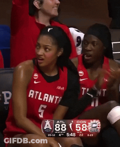 Woman In Red Atlanta Jersey Sitting On Bench GIF