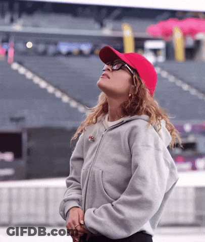 Woman In Red Baseball Cap And Glasses Looking Up GIF
