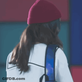 Woman In Red Beanie And Blue Backpack GIF