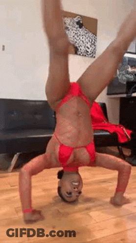 Woman In Red Bikini Doing Handstand In Living Room GIF
