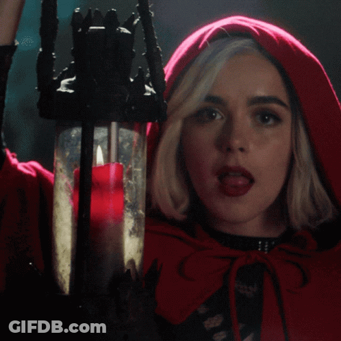 Woman In Red Cape Holding Candle GIF