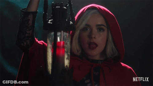 Woman In Red Cape Holding Candle With Netflix Logo GIF