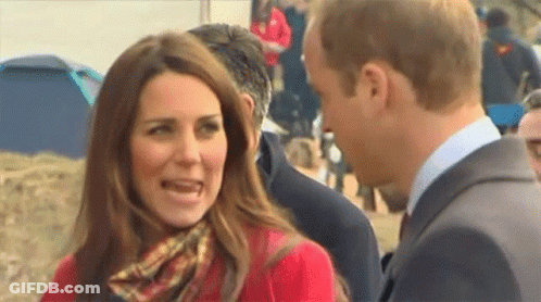 Woman In Red Coat And Scarf Next To Man GIF