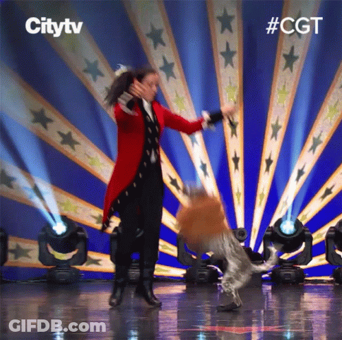 Woman In Red Coat Dancing With Dog Citytv Logo GIF