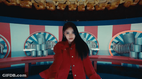 Woman In Red Coat In Front Of Razooka Carousel GIF
