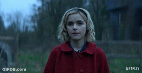 Woman In Red Coat Smiling With Netflix Logo GIF