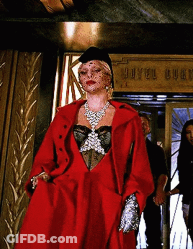 Woman In Red Coat Standing In Front Of Hotel Burch Sign GIF