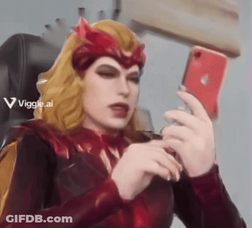 Woman In Red Costume Taking Selfie GIF