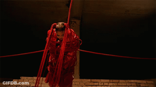 Woman In Red Costume Tied Up With Red Ropes GIF