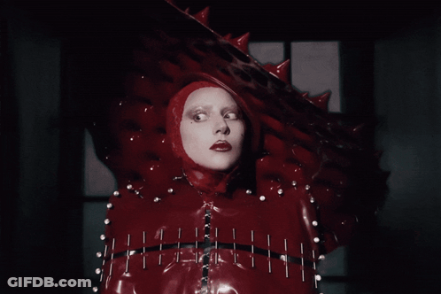 Woman In Red Costume With Head Spikes GIF