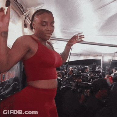 Woman In Red Crop Top Dancing By DM Sign GIF