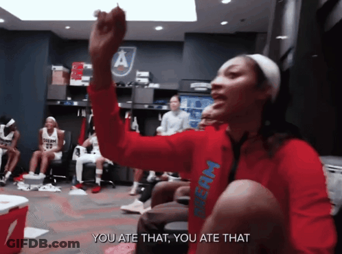Woman In Red Dream Shirt Sitting In Locker Room GIF