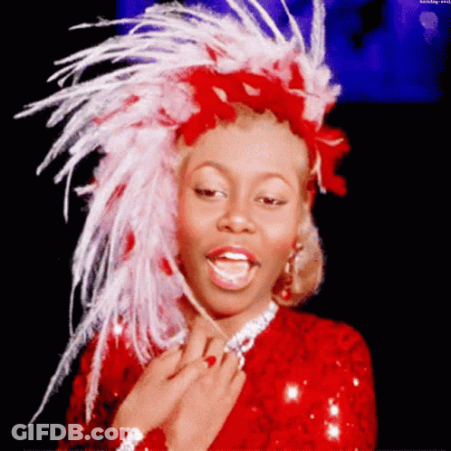 Woman In Red Dress And Feathered Headpiece GIF