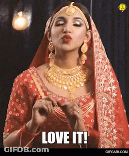 Woman In Red Dress And Gold Jewelry Saying Love It GIF