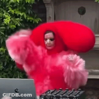 Woman In Red Dress And Hat Dancing In Front Of Laptop GIF