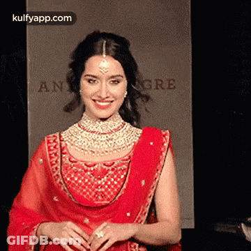 Woman In Red Dress And Jewelry Smiling GIF