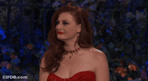 Woman In Red Dress And Necklace Looking Up GIF