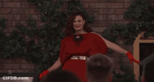 Woman In Red Dress And Red Gloves Smiling GIF
