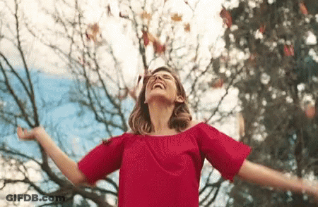 Woman In Red Dress Arms Outstretched GIF