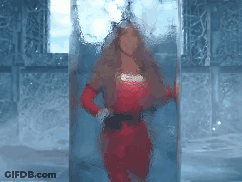 Woman In Red Dress Behind Glass Block GIF